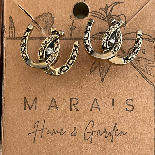 Horseshoe-shaped cufflinks on a Marais Home & Garden branded card.